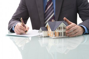 Man signs purchase agreement for a  house